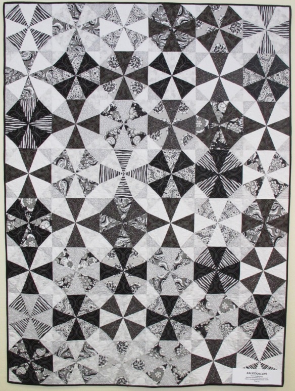 Kaleidoscope by Dawn Guglielmino, quilted by Beth Hummel, fabrics "licorice Fizz" by Carol van Zandt, p. 54 of Quilts! Quilts!! Quilts!!! 3rd edition